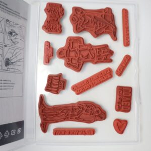 A Good Man Stamp Set cling stamps inside case – 12 red rubber stamps with masculine images and sentiments.