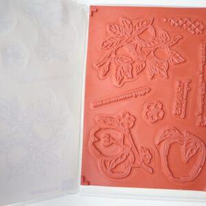 Apple Harvest cling stamps mounted inside the case, showing apple and floral designs.