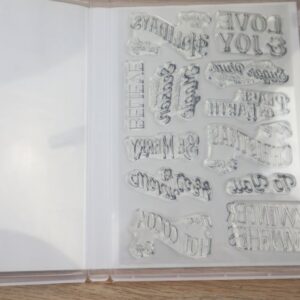 Christmas Labels photopolymer stamp set shown inside the case with all 12 clear holiday sentiment stamps.