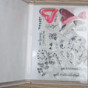 Country Bouquet photopolymer stamp set shown inside its case with all 16 clear stamps arranged on the backing sheet.