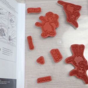 Red rubber cling stamps from the Darling Donkeys set arranged inside the open case.