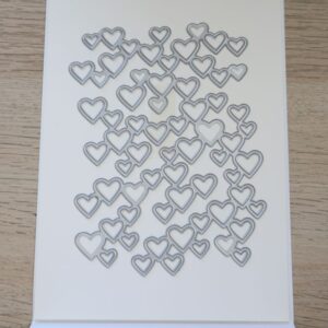 Detailed Hearts background die on white cardstock
