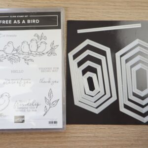 Free As a Bird stamp set displayed beside the Stitched Nested Labels Dies on a wooden background.