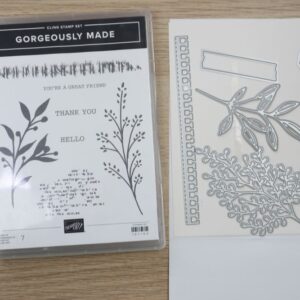 Gorgeously Made cling stamp set next to coordinating dies on a wooden background