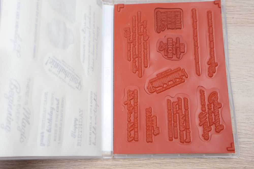 Open In Your Words stamp set showing red rubber cling stamps inside the case.