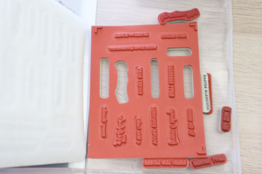 Itty Bitty Greetings red rubber stamp sheet with multiple mini sentiment stamps.