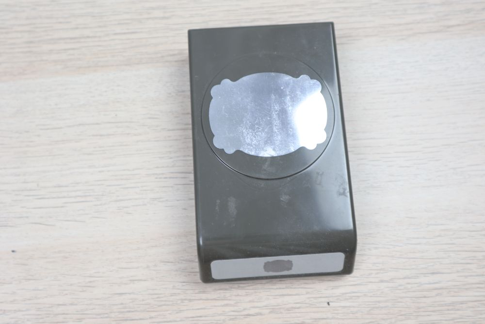 Stampin’ Up! Lasting Label Punch used condition on a wooden background.