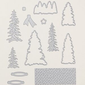 Silver outline-style metal dies from the Peaceful Evergreens bundle arranged neatly on a white surface.