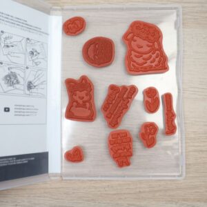 Springtime Joy red rubber cling stamps displayed inside the stamp case.