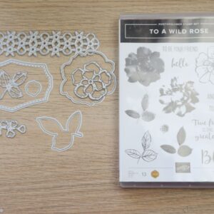 To a Wild Rose bundle with stamp set and coordinating dies displayed on a wooden background